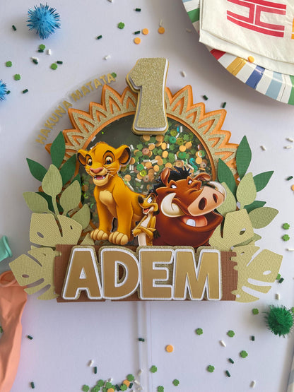 Decorative cake topper with characters from 'The Lion King' and the name 'ADEM'.